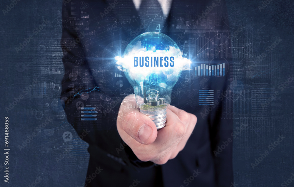 Businessman holding a light bulb, business concept Businessman holding a light bulb, business concept
