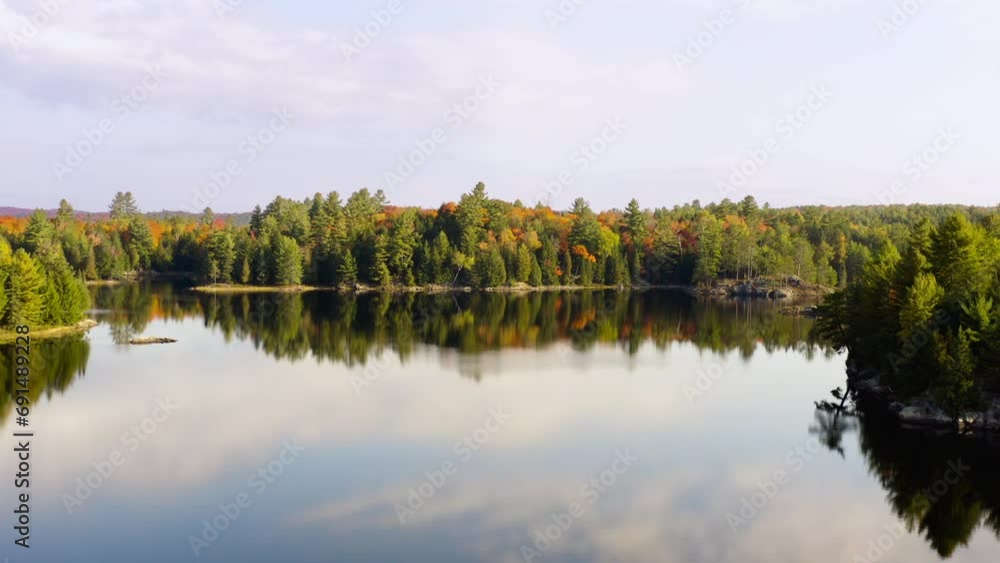 Pan and rise over a lake in autumn Pan and rise over a lake in autumn