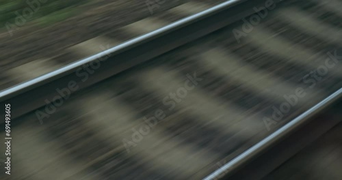 Train cargo by rails. Dark, gloomy train tracks, close up. Goods transportation over long distances by train rails. Import, export by train line. Railroad track. Railway logistic. Transport industry photo
