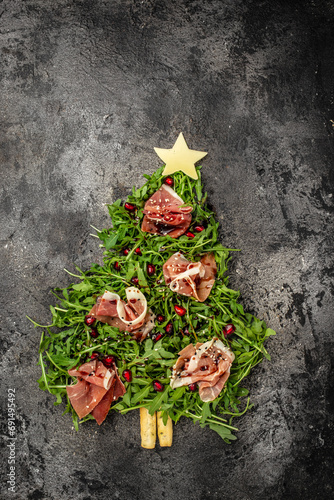 Jamon Prosciutto and arugula Salad, Christmas food tree Antipasto. top view