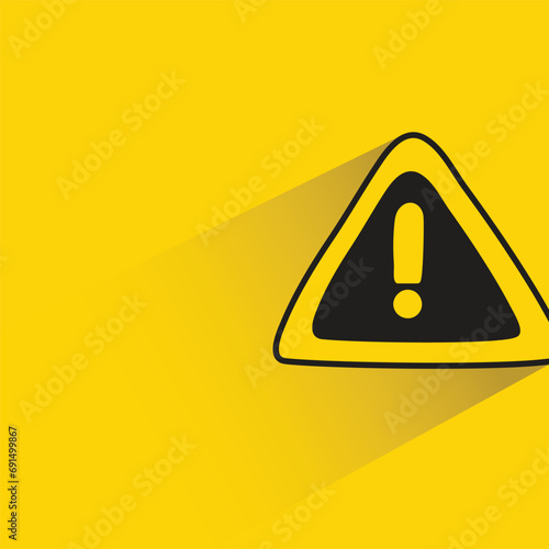caution signage with shadow on yellow background
