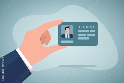 Human hand holding a ID card.