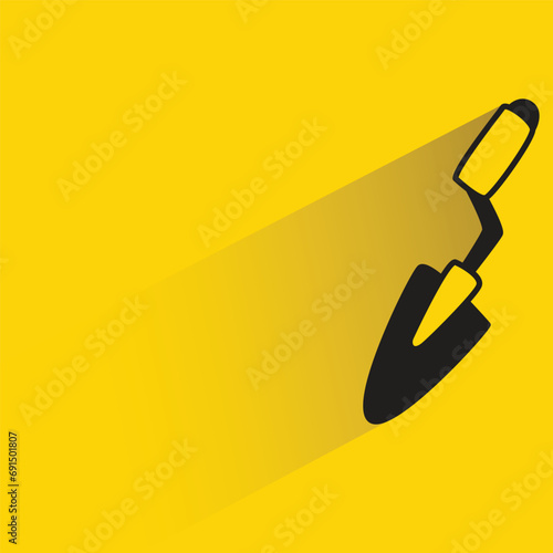 doodle trowel with shadow on yellow background