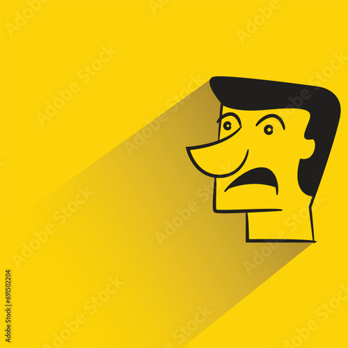 amazed face with shadow on yellow background