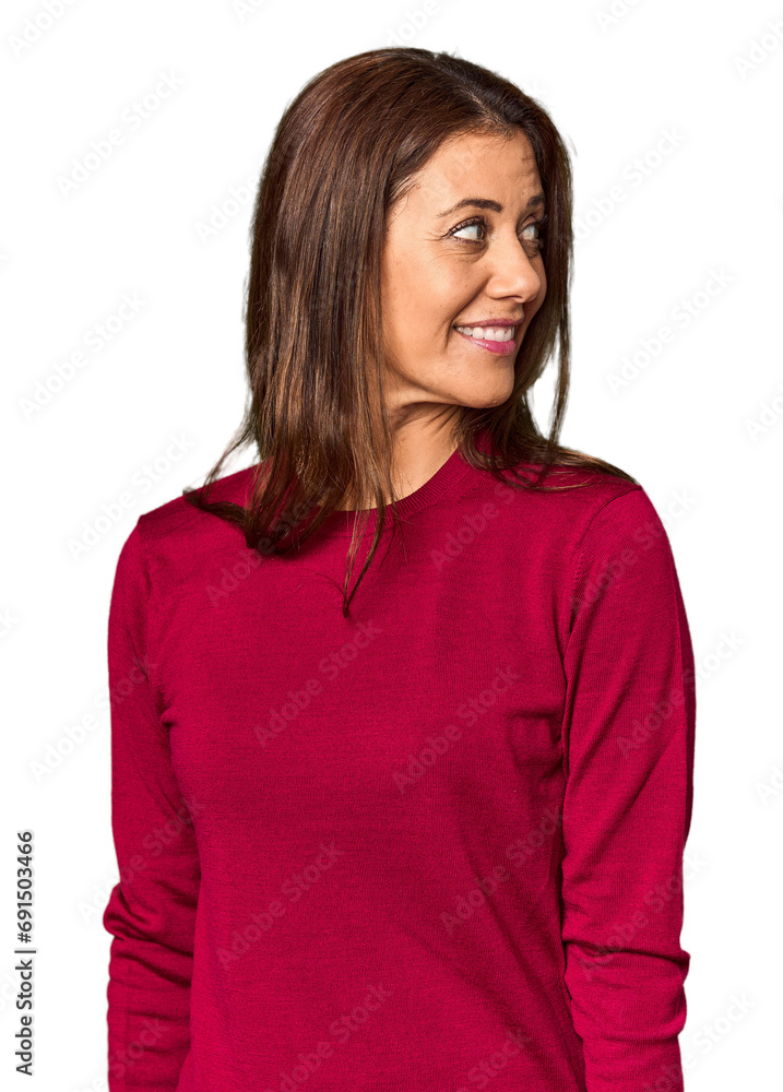 Elegant middle-aged Caucasian woman in studio setting looks aside smiling, cheerful and pleasant. Elegant middle-aged Caucasian woman in studio setting looks aside smiling, cheerful and pleasant.