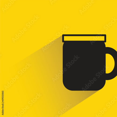 water glass with shadow on yellow background