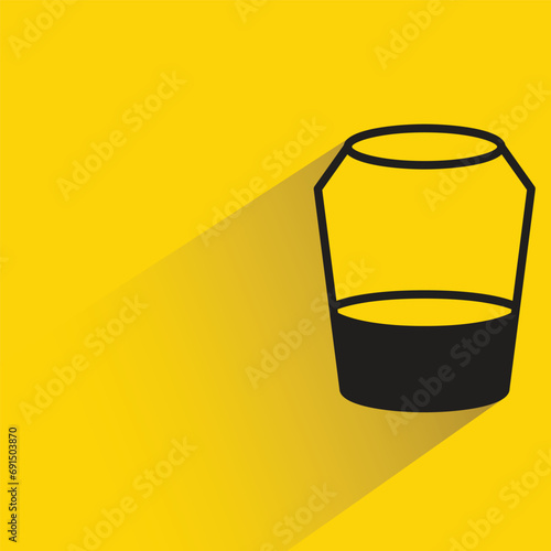 water glass with shadow on yellow background