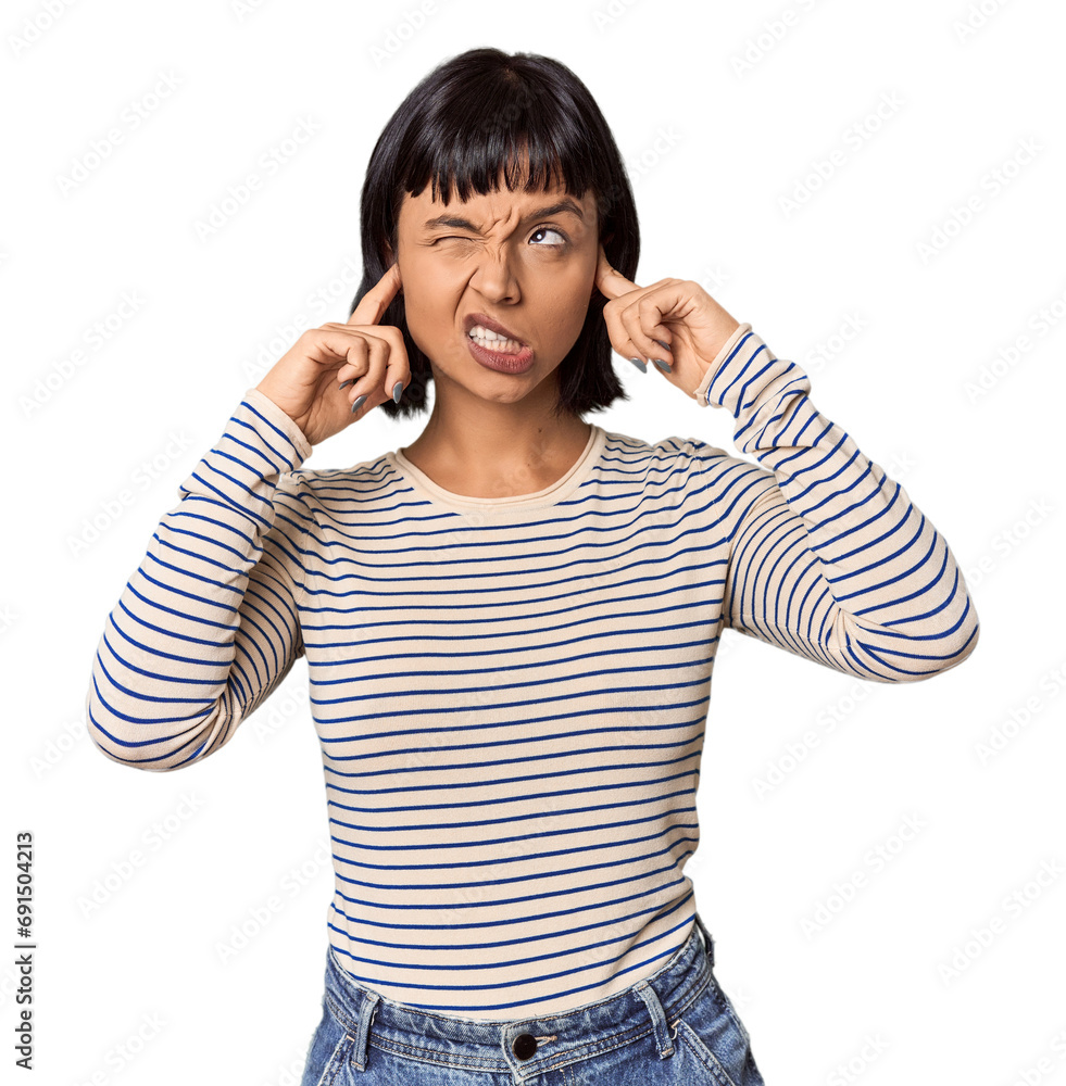 Young Hispanic woman with short black hair in studio covering ears with fingers, stressed and desperate by a loudly ambient. Young Hispanic woman with short black hair in studio covering ears with fingers, stressed and desperate by a loudly ambient.