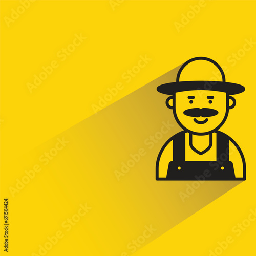 old farmer with shadow on yellow background