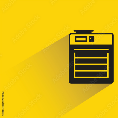 electric oven with shadow on yellow background