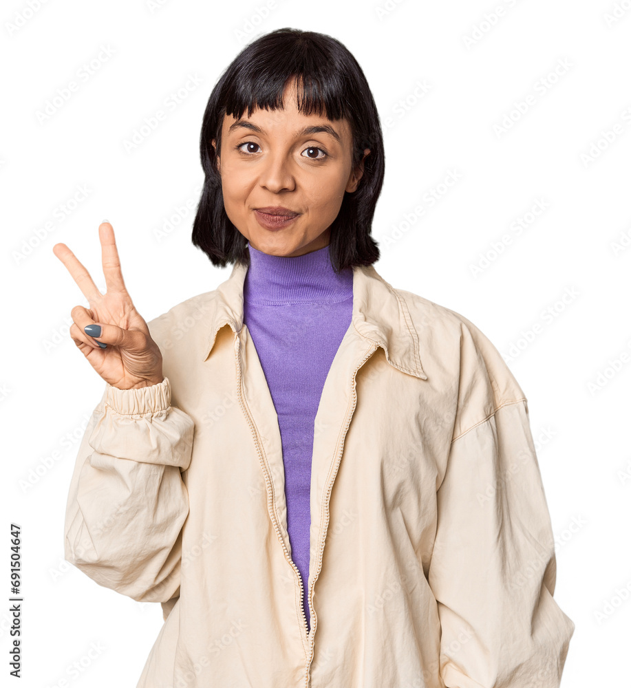 Young Hispanic woman with short black hair in studio showing victory sign and smiling broadly. Young Hispanic woman with short black hair in studio showing victory sign and smiling broadly.