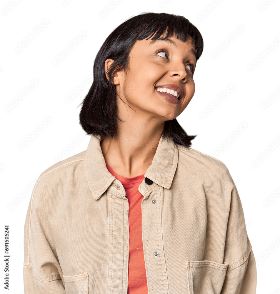 Young Hispanic woman with short black hair in studio relaxed and happy laughing, neck stretched showing teeth. Young Hispanic woman with short black hair in studio relaxed and happy laughing, neck stretched showing teeth.