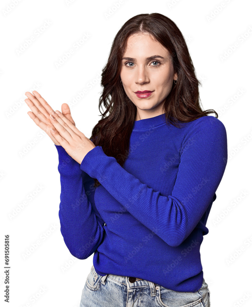 Young Caucasian woman in a studio setting feeling energetic and comfortable, rubbing hands confident. Young Caucasian woman in a studio setting feeling energetic and comfortable, rubbing hands confident.