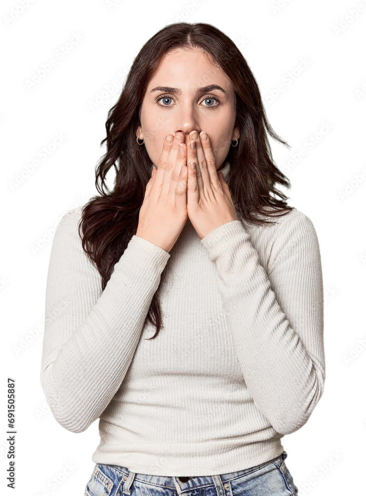Young Caucasian woman in a studio setting shocked, covering mouth with hands, anxious to discover something new. Young Caucasian woman in a studio setting shocked, covering mouth with hands, anxious to discover something new.