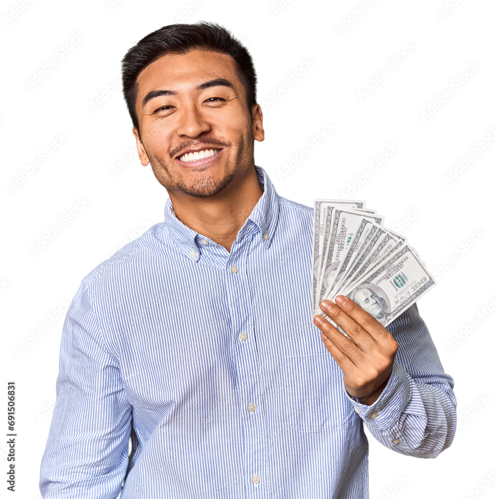 Young Chinese man holding dollar bills in studio happy, smiling and cheerful. Young Chinese man holding dollar bills in studio happy, smiling and cheerful.