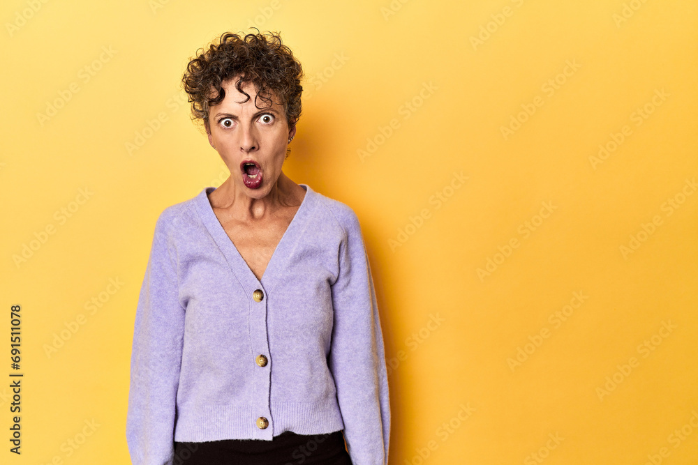 Mid-aged caucasian woman on vibrant yellow shouting very angry, rage concept, frustrated. Mid-aged caucasian woman on vibrant yellow shouting very angry, rage concept, frustrated.