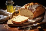 A Morning Delight: Freshly Baked Loaf of White Bread with Creamy Butter on a Rustic Table