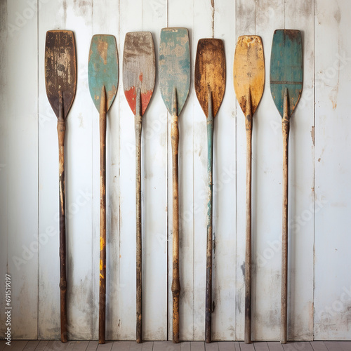 Illustration of wooden oars painted in vintage style. Canoe paddles lined up against an old wooden background. Natural wood canoe paddles. photo