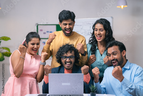 Group of team members celebrating success after seeing received mail from the laptop at office - concept of project deal, new business or client agreement and startup collaboration © WESTOCK
