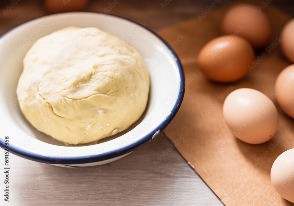 Dough in an enamel bowl and eggs Dough in an enamel bowl and eggs