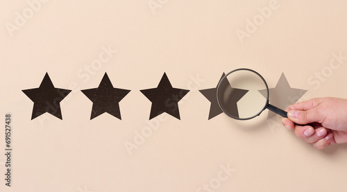 Five star rating and a magnifying glass in a woman s hand. Customer reviews