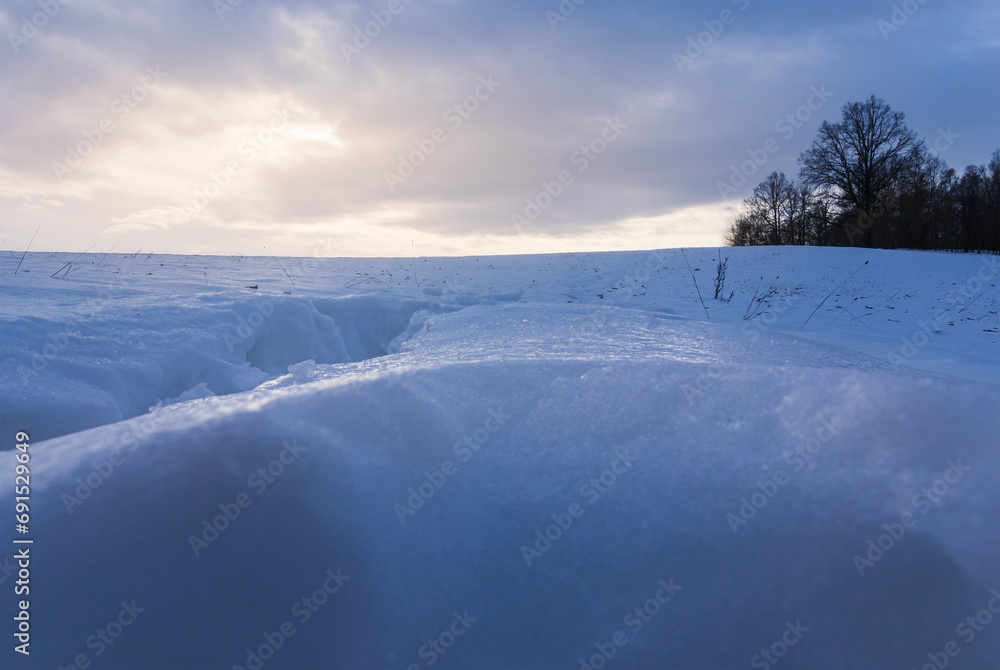 Simple Czech winter landscape scene with snow and trees under sunrise sky Simple Czech winter landscape scene with snow and trees under sunrise sky