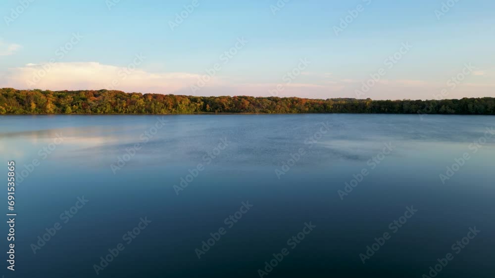 Beautiful fall scenery. Stunning morning view of calm water lake with a reflection of colorful autumn forest. Beautiful fall scenery. Stunning morning view of calm water lake with a reflection of colorful autumn forest.