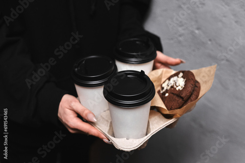 Women's hands hold coffee with chocolate cookies. Mockup. © Лев Малевич