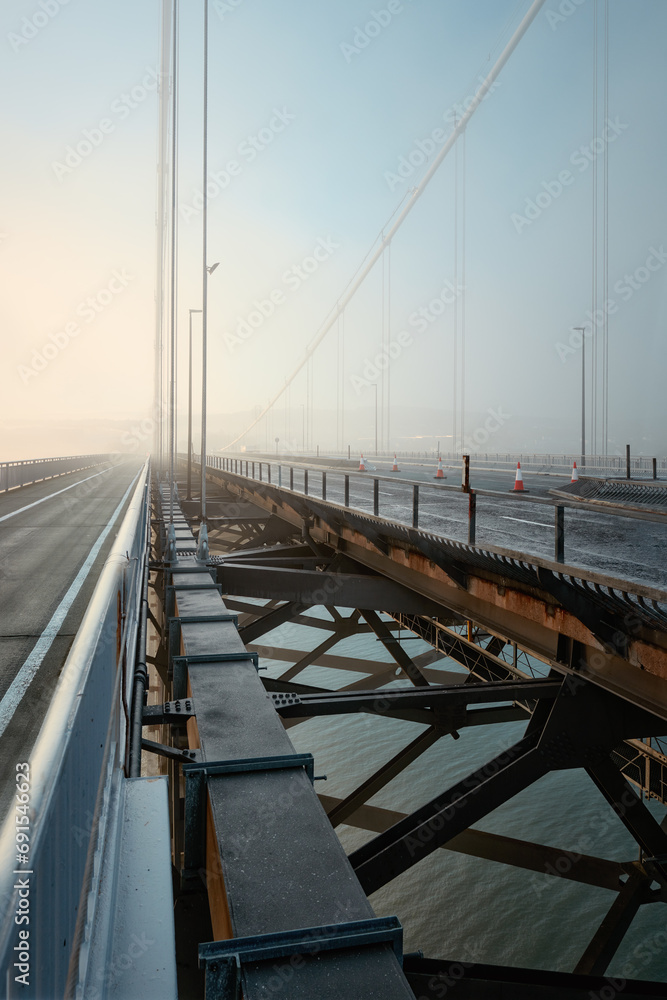 Forth Road Bridge covered in thick fog in the early morning. Scotland, United Kingdom