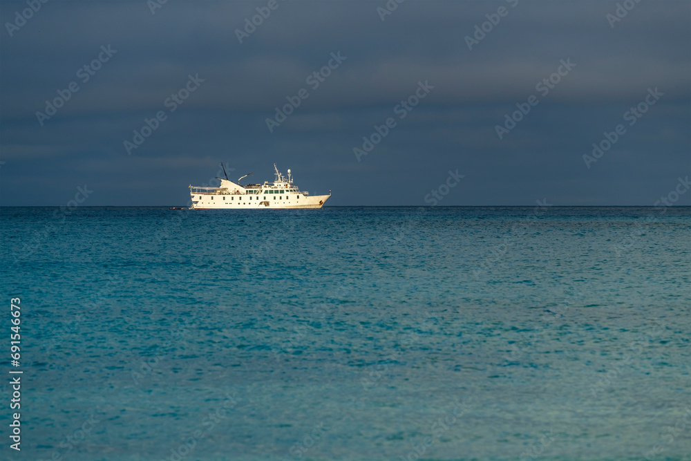 Cruise ship at anchor by Gardner Bay, Espanola Island, Galapagos national park, Ecuador.