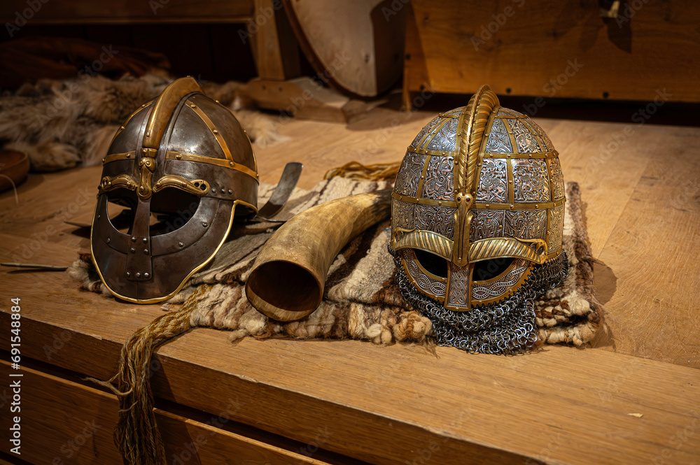 two viking helmets on a wooden table