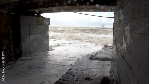 A strong storm destroyed the coastal railway. The tunnel (culvert) under the road has been destroyed photo