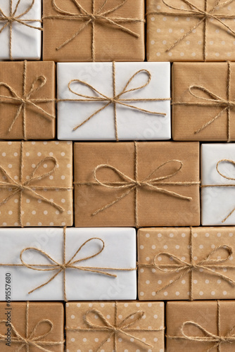 Festive background of gift boxes wrapped in kraft paper