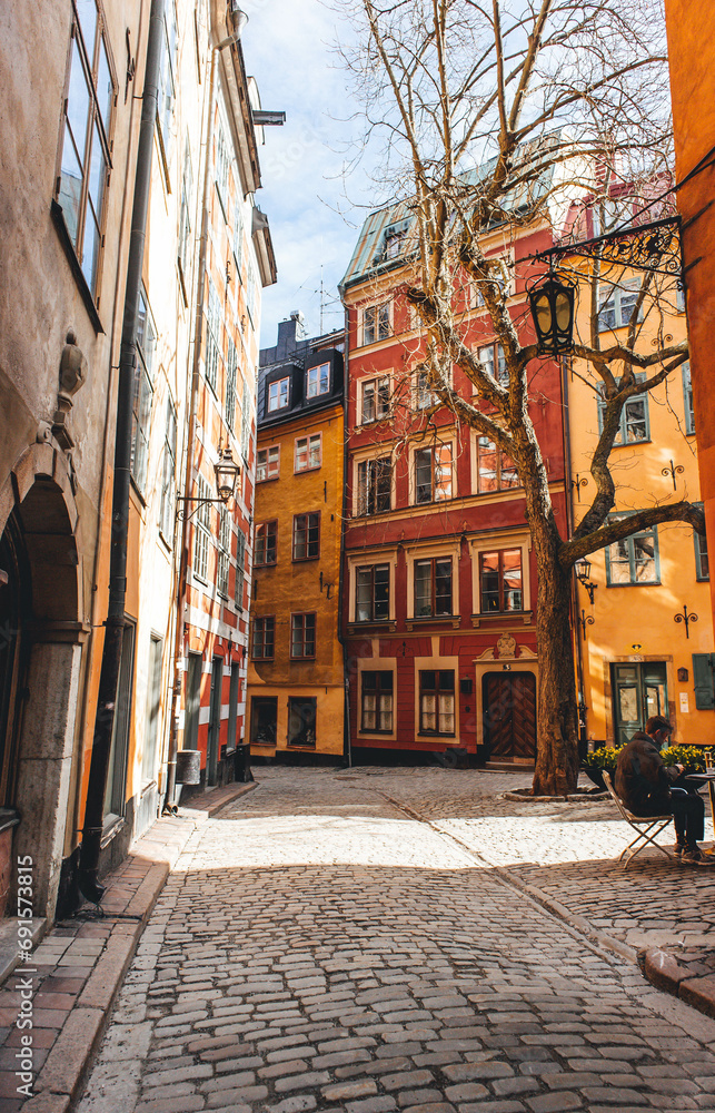 morning beautiful light on narrow street in old town with orange walls in stockholm