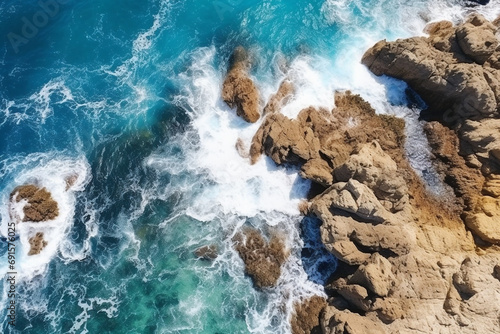 Aerial view of sea with water hitting the rocks