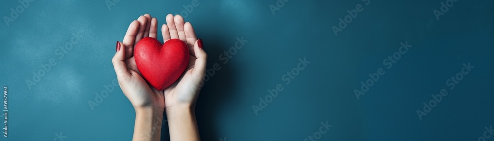 Hands hold a red heart on a isolated background Hands hold a red heart on a isolated background