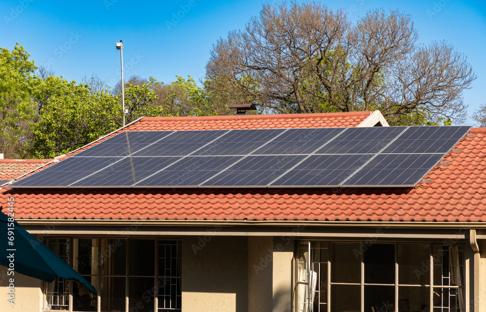 Fototapeta premium Solar panels, aimed at mitigating 'load-shedding' or blackouts, are seen on a residential roof in a suburb of Johannesburg, South Africa