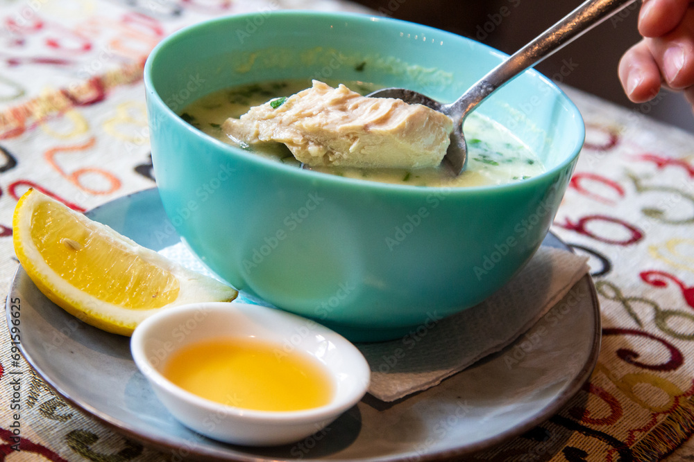 travel to Georgia - eating Chikhirtma (Georgian soup from chicken broth, thickened with beaten eggs and curd) in local cafe in Tbilisi city travel to Georgia - eating Chikhirtma (Georgian soup from chicken broth, thickened with beaten eggs and curd) in local cafe in Tbilisi city