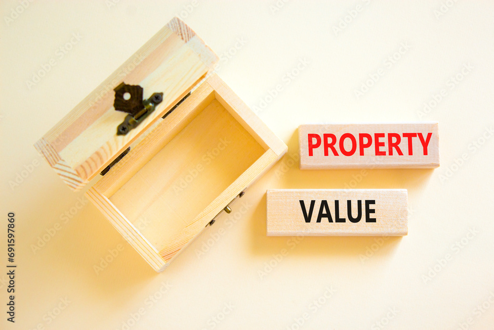 Property value symbol. Concept words Property value on beautiful wooden blocks. Beautiful white table white background. Empty beautiful wooden chest. Business property value concept. Copy space. Property value symbol. Concept words Property value on beautiful wooden blocks. Beautiful white table white background. Empty beautiful wooden chest. Business property value concept. Copy space.