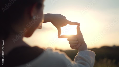 Travel freedom a concept, Close up of traveler woman hands making frame gesture with sunrise in summer, Female capturing the sunrise photo