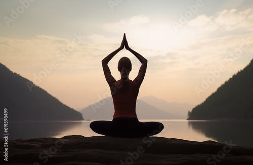  Woman practicing yoga in mountains, meditating outdoors. Meditation, healthy lifestyle, relaxation, yoga, self care, mindfulness concept