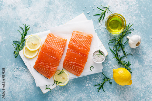 Salmon. Fresh raw salmon fish fillet with cooking ingredients, herbs and lemon, top view