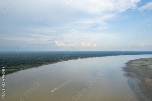 Aerial view of the Amazon river. Boat cruising in the middle