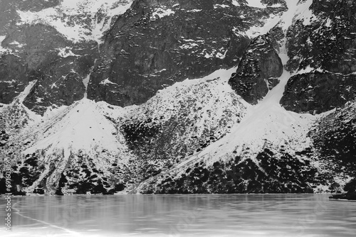 Black and white panorama of winter mountains. view from frozen lake. Morskie oko Tatra Poland