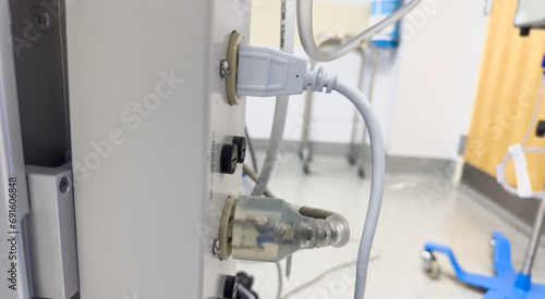white electrical outlet on a wall with cords plugged in, emitting energy and connectivity in a modern setting