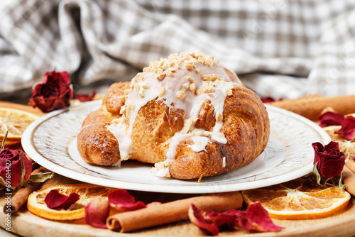 Saint Martin's croissant. Traditional polish cake with poppy seed filling decorated with icing and nuts photo