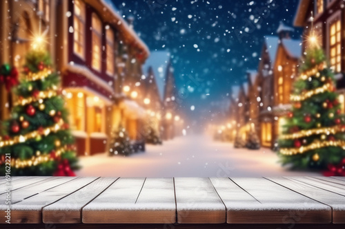 christmas table in the city. Empty wooden table top with blurry Christmas town and snowfall background. Christmas holiday background. © Alisa