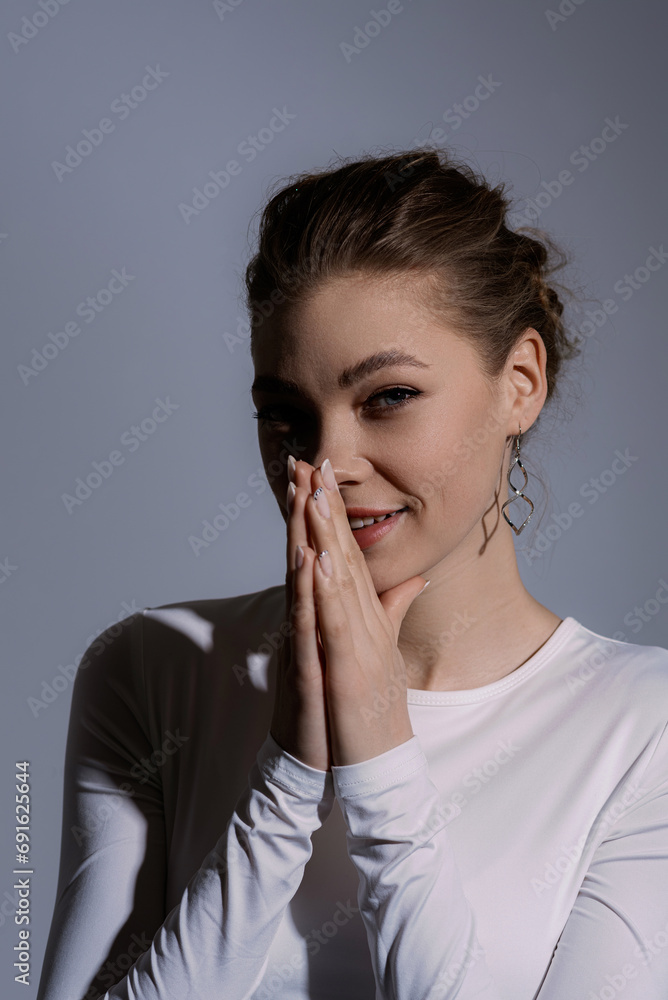 Sexy Caucasian young woman with a stylish beige suit in the studio. A model with a perfect body, make-up, dressed in elegant clothes Sexy Caucasian young woman with a stylish beige suit in the studio. A model with a perfect body, make-up, dressed in elegant clothes