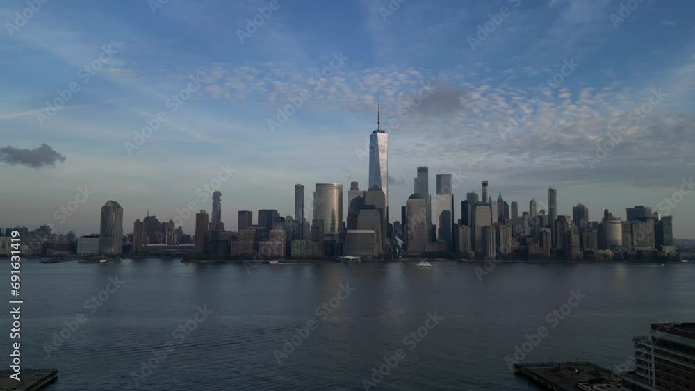 still shot of nyc skyline (downtown manhattan, new york city) view from jersey city waterfront (hudson river harbor) aerial drone 4k footage (still, water flowing, moving, pan) rising (skyscrapers) still shot of nyc skyline (downtown manhattan, new york city) view from jersey city waterfront (hudson river harbor) aerial drone 4k footage (still, water flowing, moving, pan) rising (skyscrapers)