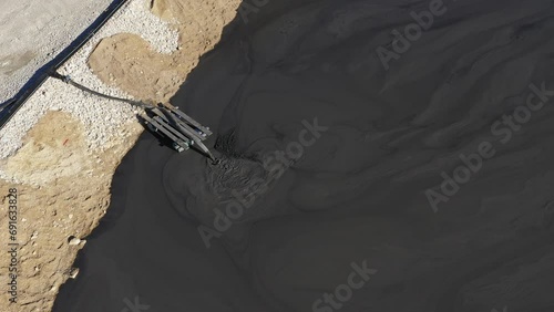 Aerial view of mining residuals flowing into decanting pond from a copper mine. Geamana, Rosia Montana Romania photo